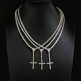 Gold, Silver and Rose Gold slender cross drop necklaces displayed on a black bust