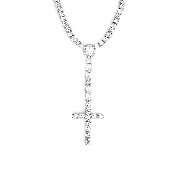 Silver-tone cross drop tennis necklace with an oval halo and rectangular stone accents on white