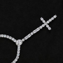 Silver-tone cross drop necklace showing the oval halo, rectangular accents and stone-set cross on black