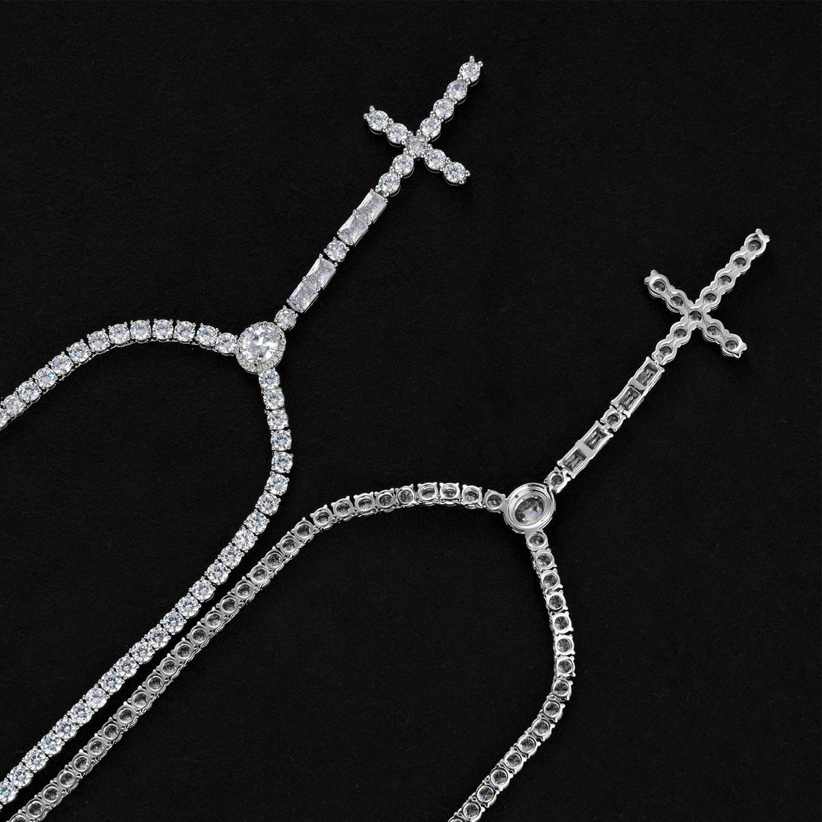 Front and reverse of the wider silver-tone cross drop tennis necklace showing open settings