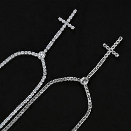 Front and reverse of the wider silver-tone cross drop tennis necklace showing open settings