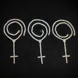 Rose Gold, Silver and Gold cross drop tennis necklaces arranged in coils on black