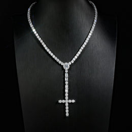 Silver-tone wider cross drop tennis necklace displayed on a black bust