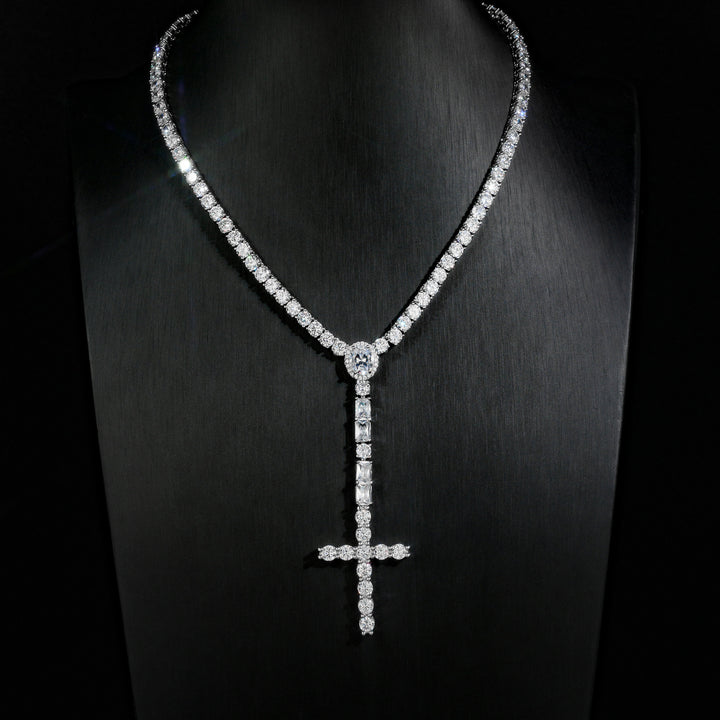 Silver-tone wider cross drop tennis necklace displayed on a black bust
