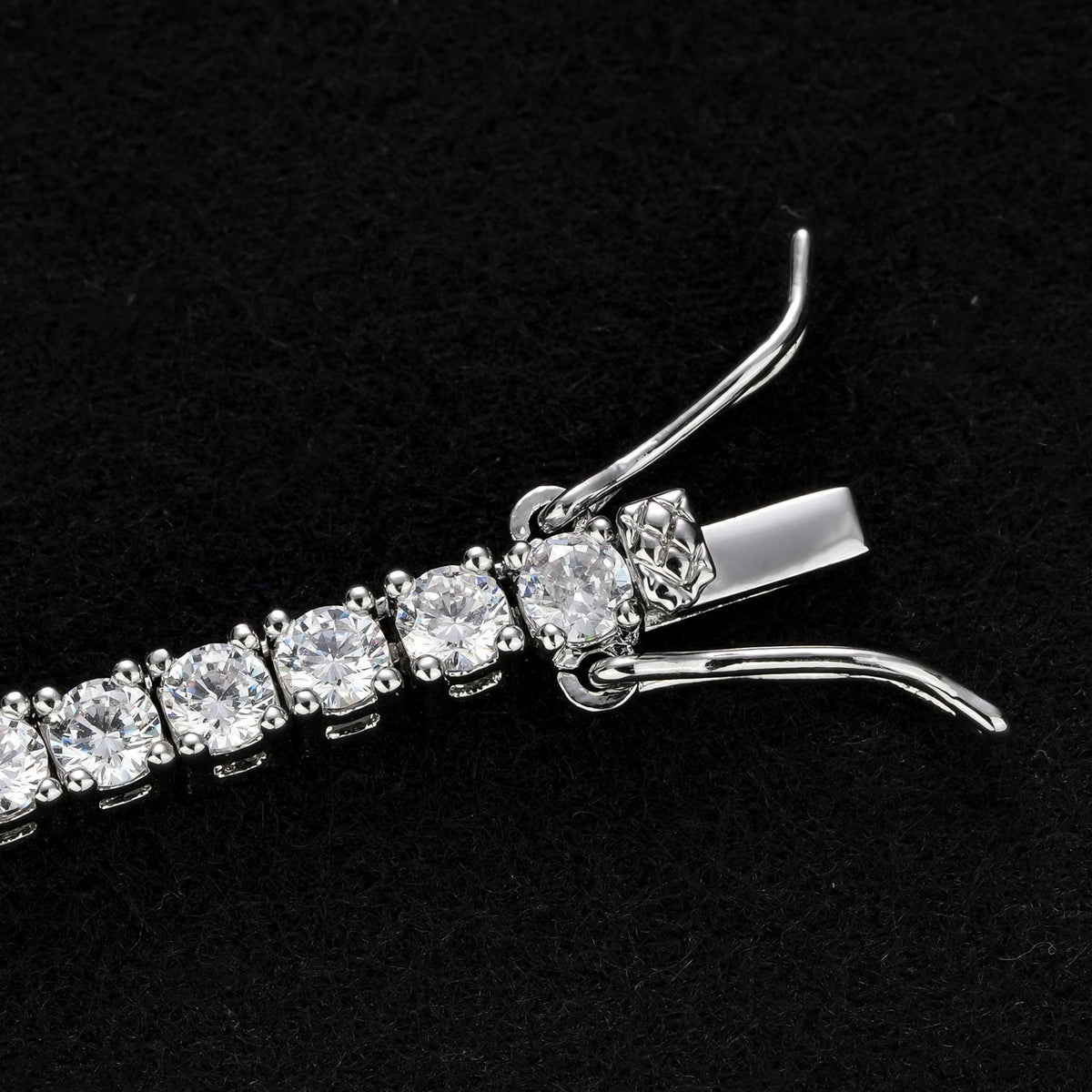 Close-up of the silver-tone tennis necklace box clasp and open side safety catches