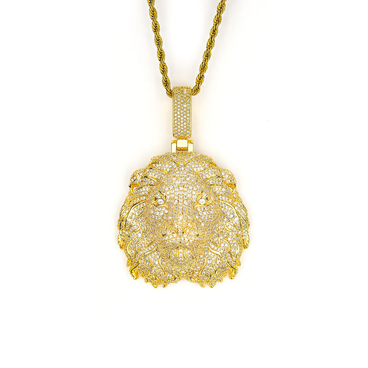 Gold-tone lion head pendant with stone-set mane on white