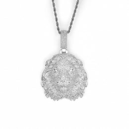 Silver-tone lion head pendant with stone-set mane on white