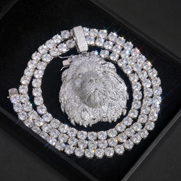 Silver-tone lion head pendant displayed in a black box