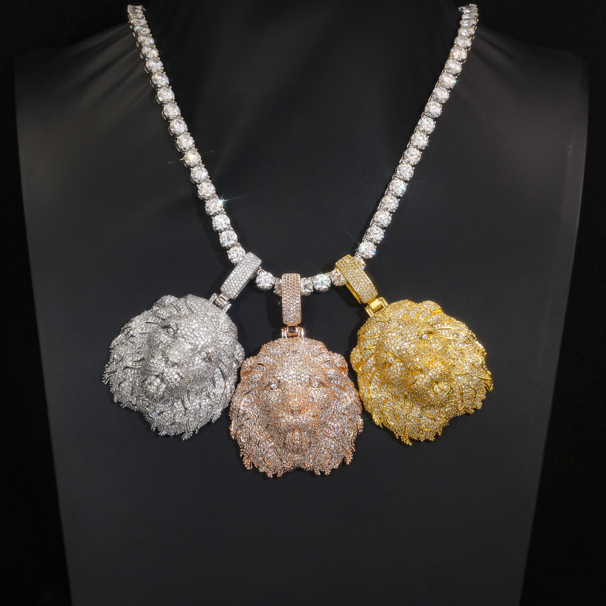 Silver-tone, rose-gold-tone and gold-tone lion head pendants on a black display bust