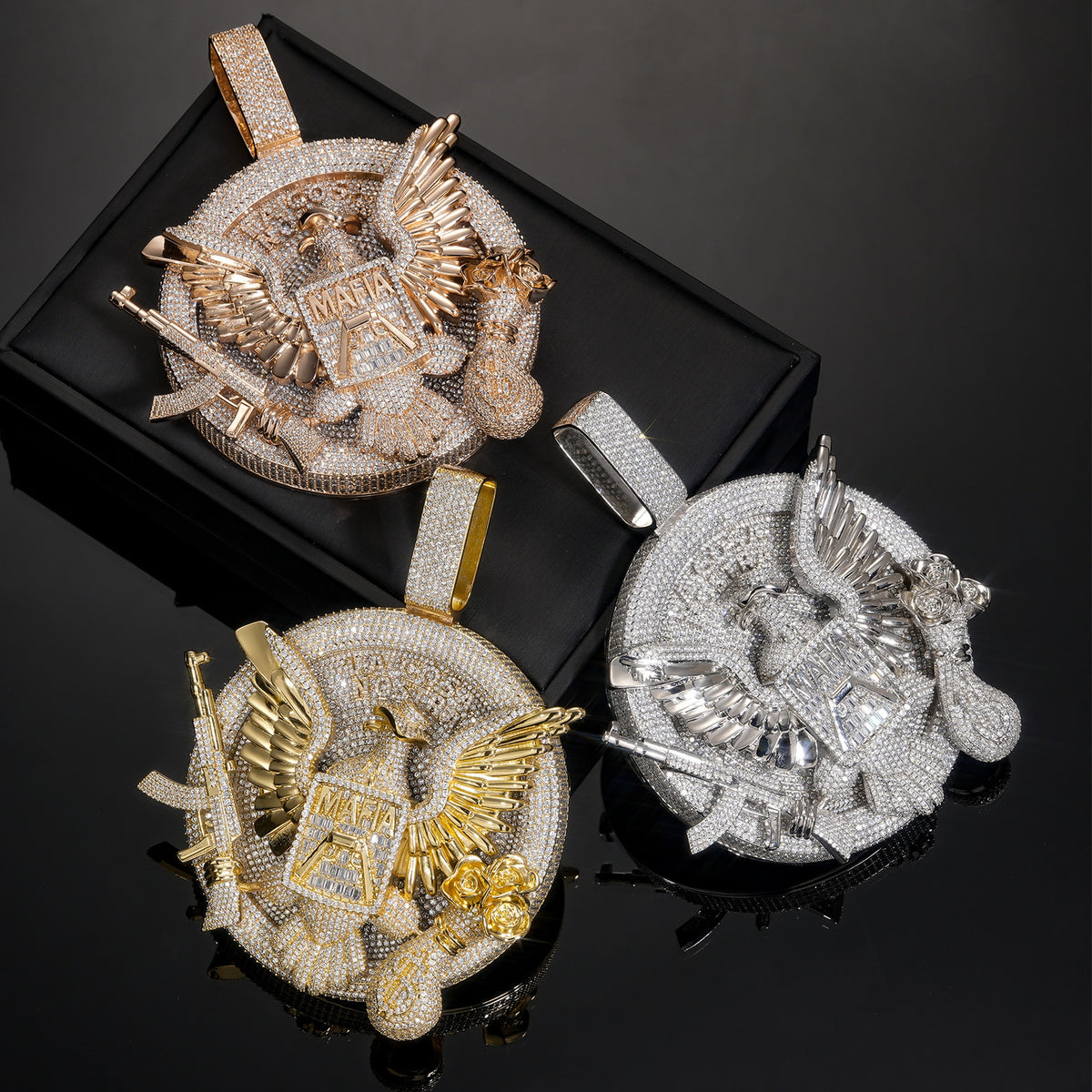 Three eagle medallion pendant finishes on a black display