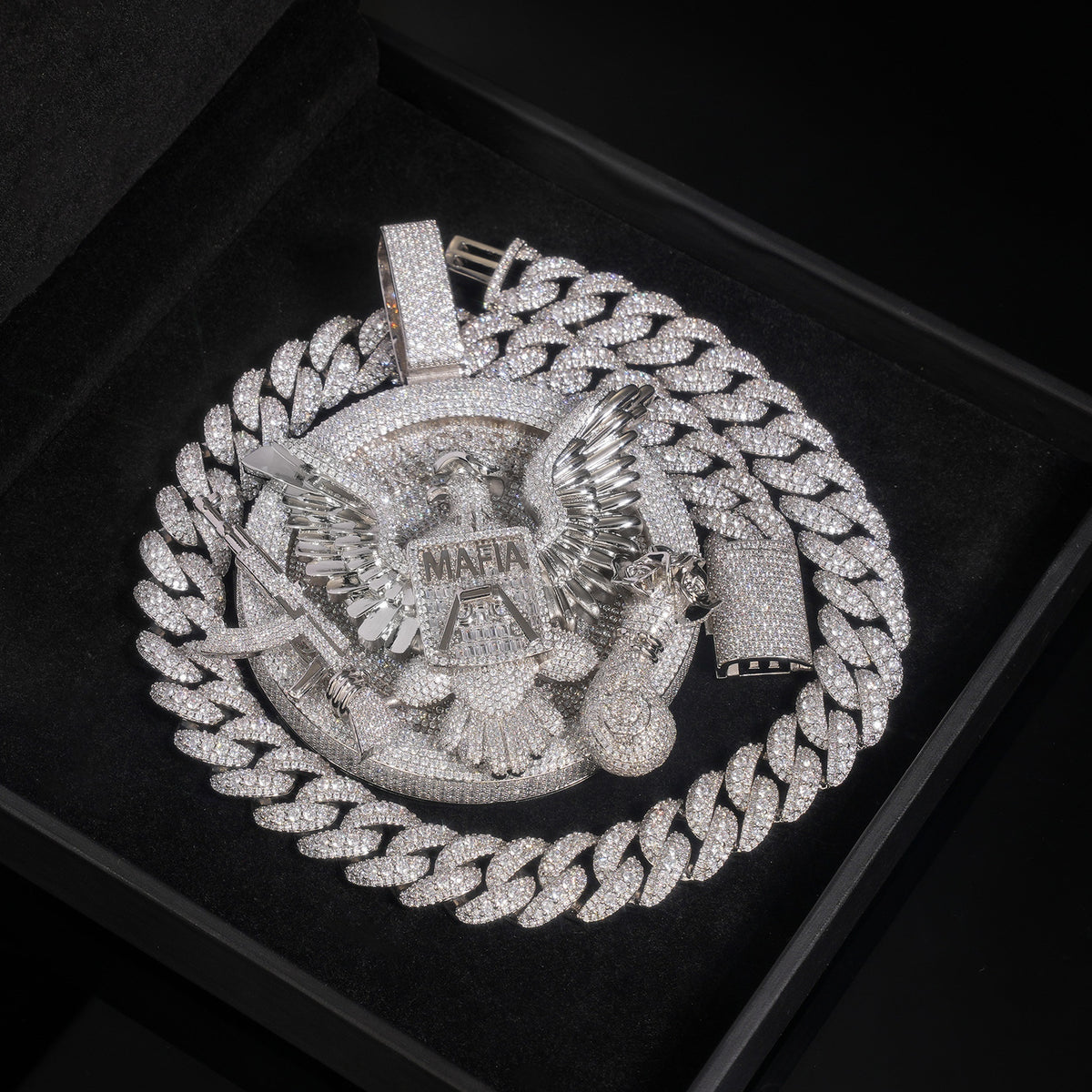 Silver-tone eagle medallion pendant on a black display