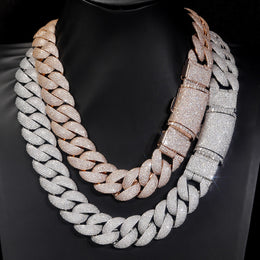 Silver and gold-tone iced bubble Cuban link chains on black