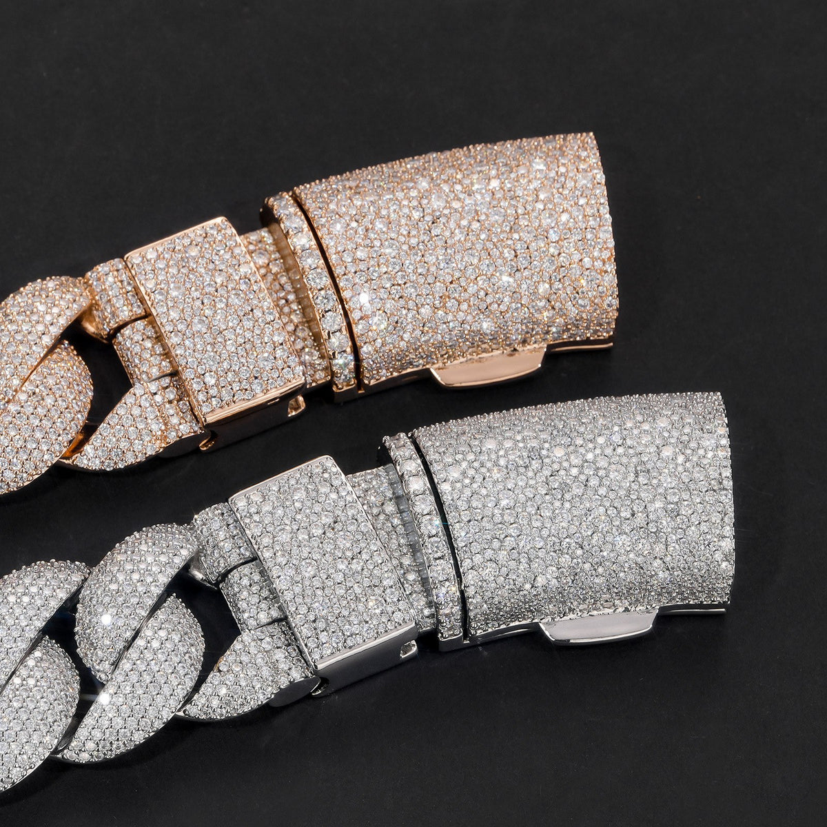 Close-up of silver and gold-tone iced bubble Cuban chain box clasps