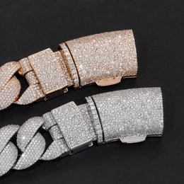 Close-up of silver and gold-tone iced bubble Cuban chain box clasps