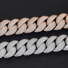 Close-up of silver and gold-tone iced bubble Cuban chain links