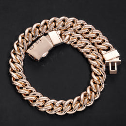 Gold-tone iced bubble Cuban link chain coiled on black