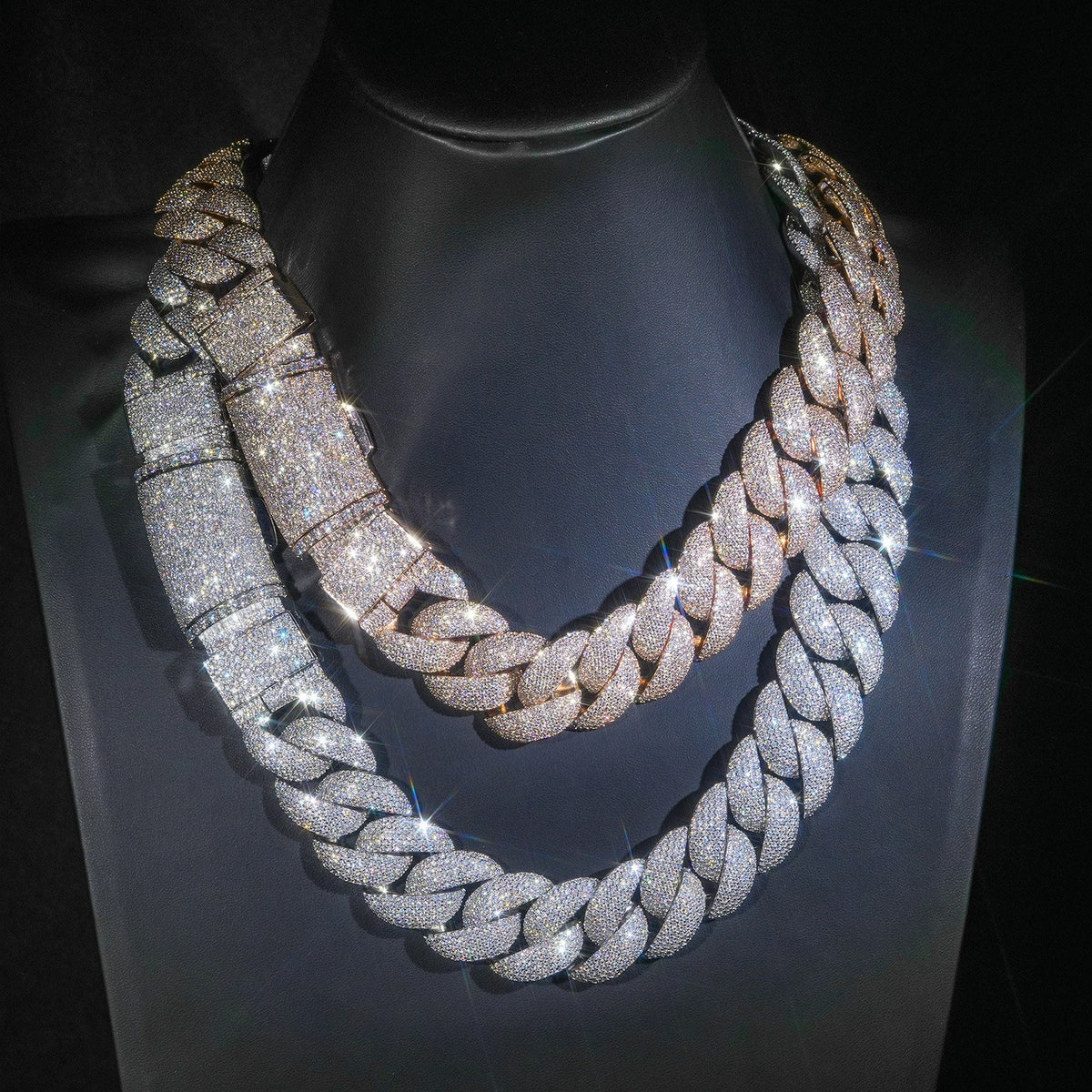 Silver and gold-tone iced bubble Cuban chains on display stands