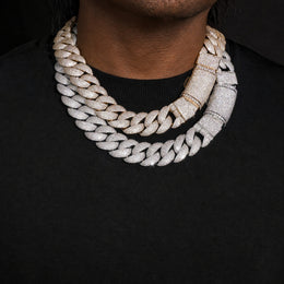 Model wearing silver and gold-tone iced bubble Cuban link chains