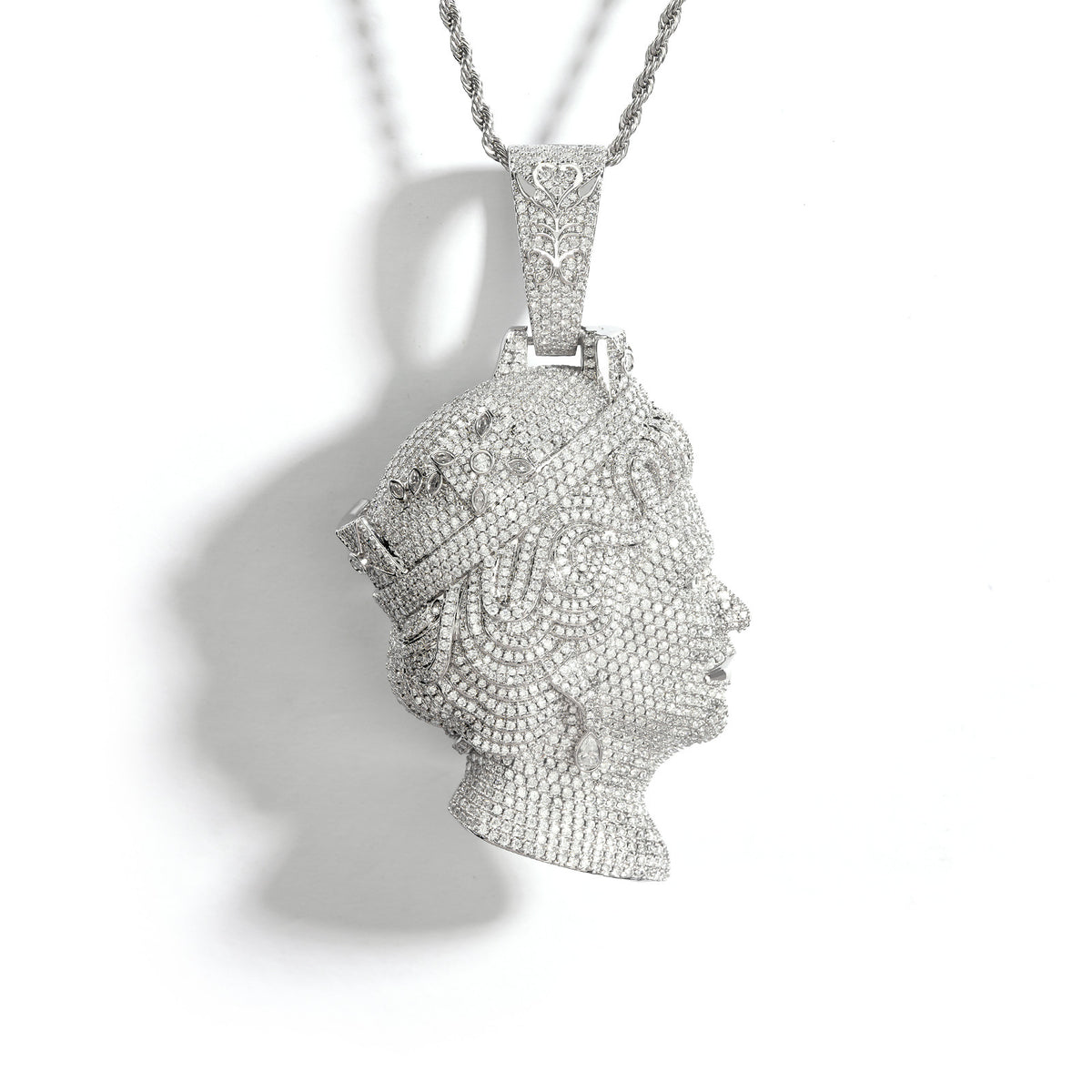 Silver-tone queen portrait pendant with a pavé face and tiara on white