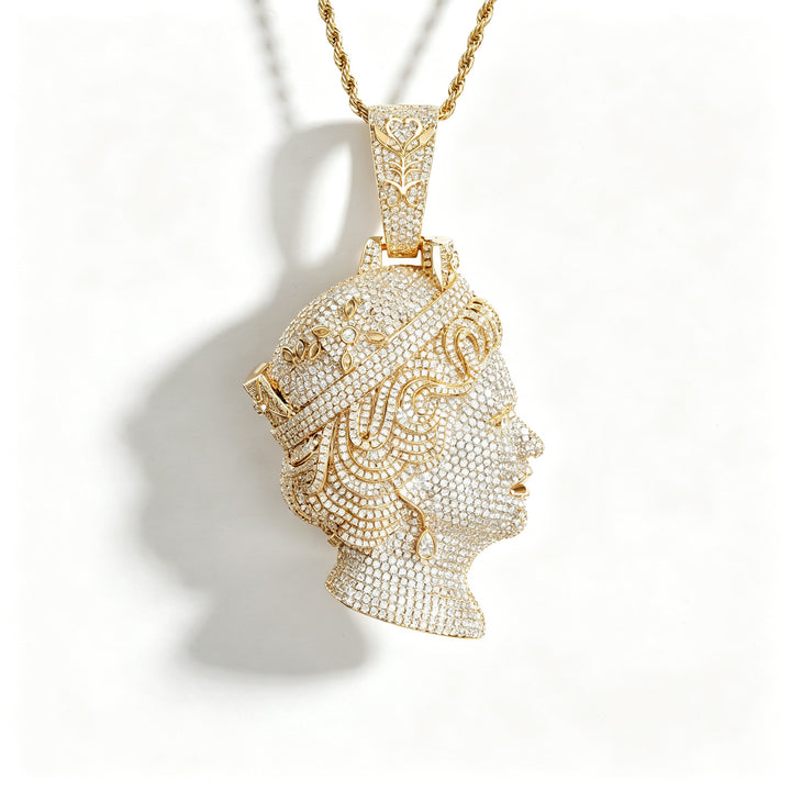 Gold-tone queen portrait pendant with a pavé face and tiara on white