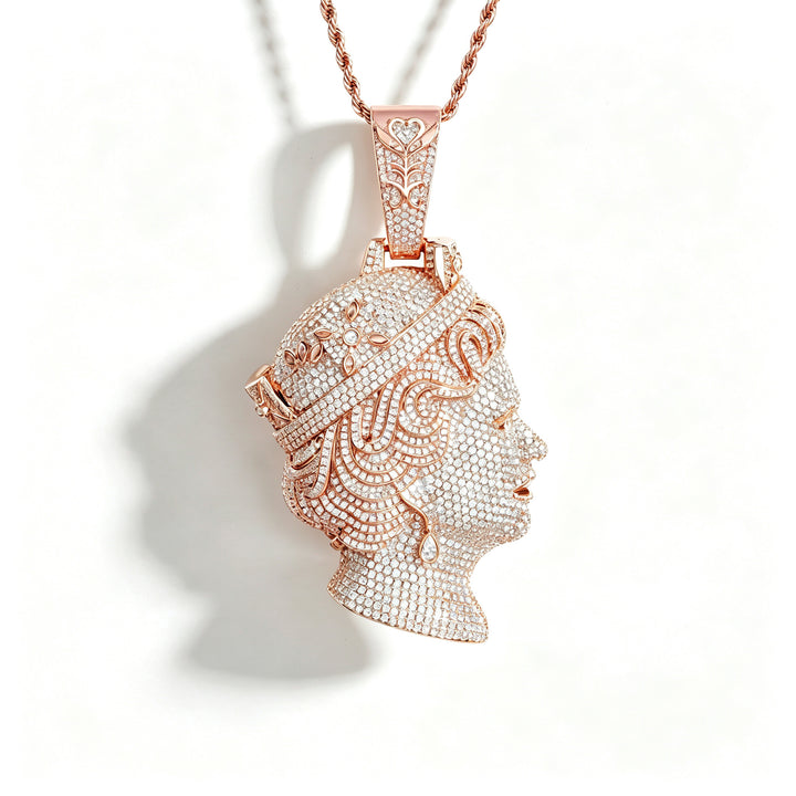 Rose-gold-tone queen portrait pendant with a pavé face and tiara on white