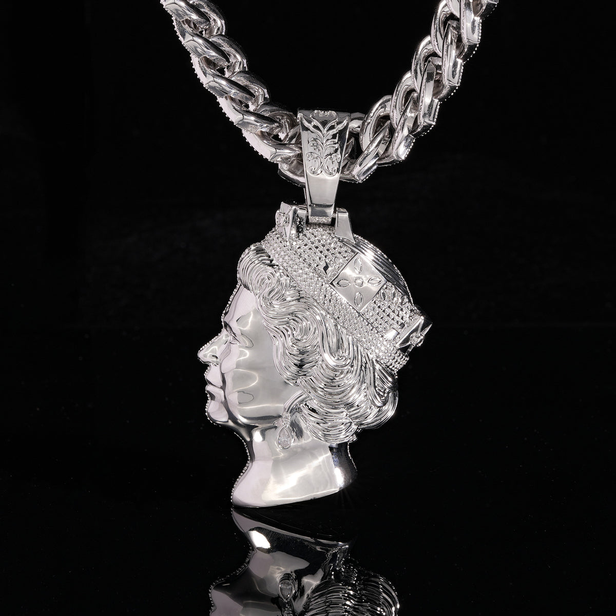 Silver-tone queen portrait pendant showing the polished sculpted side against black