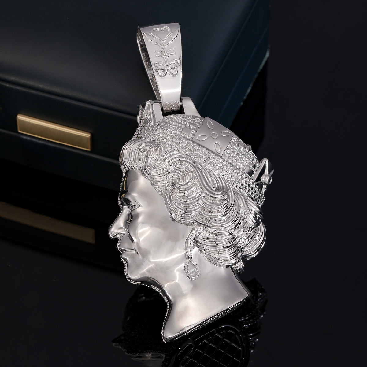 Polished side of the silver-tone queen portrait pendant with tiara and sculpted curls