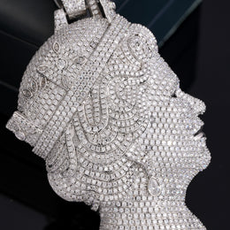 Close-up of the silver-tone queen portrait pendant showing pavé stones and decorative details