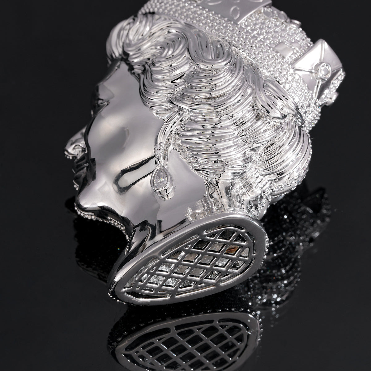 Silver-tone queen portrait pendant showing sculpted curls and the open lattice base