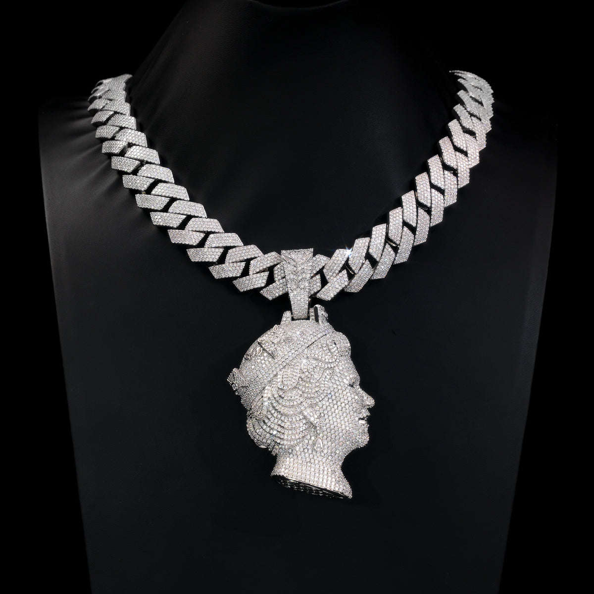 Silver-tone iced queen portrait pendant displayed on a black jewelry bust
