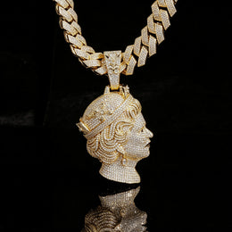 Gold-tone iced queen portrait pendant with its ornate bail against a black backdrop