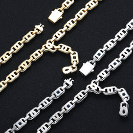 Backs of silver- and gold-tone geometric links and their open clasps