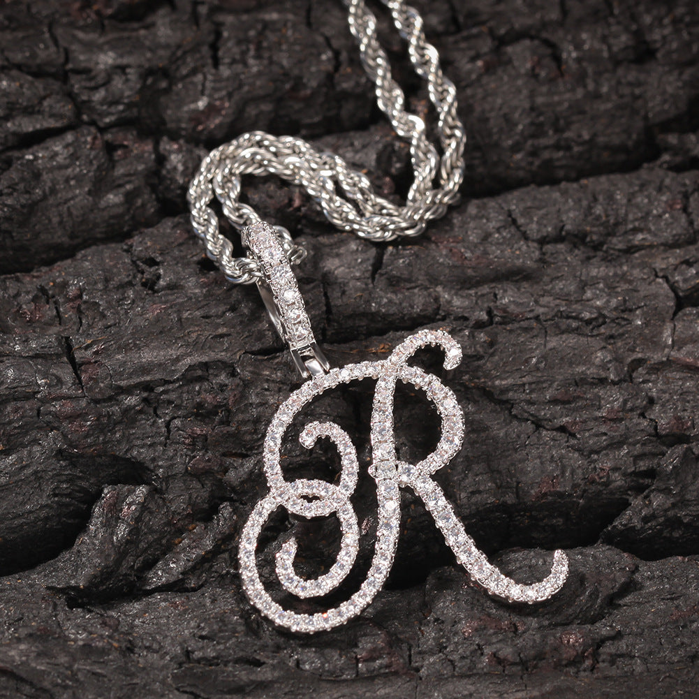 Silver-tone cubic zirconia script letter R pendant on bark