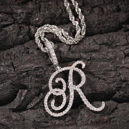 Silver-tone cubic zirconia script letter R pendant on bark