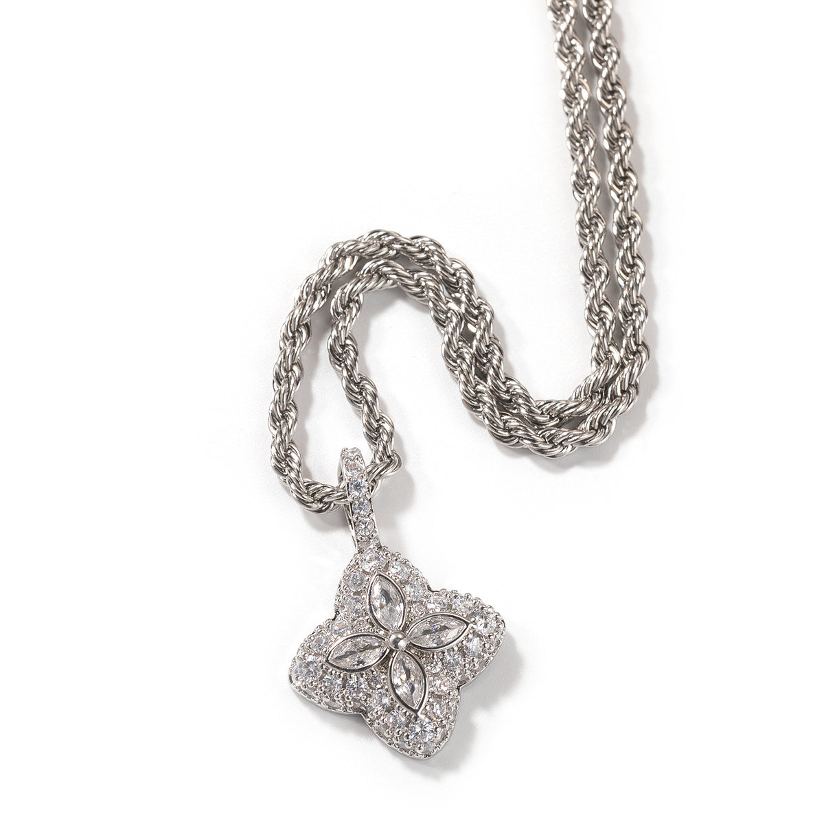 Clear-stone four-leaf clover pendant in a silver-tone setting on white