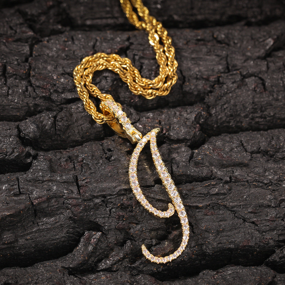 Gold-tone cubic zirconia script letter J pendant on bark