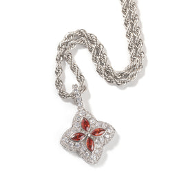 Garnet-red four-leaf clover pendant in a silver-tone setting on white