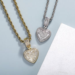 Gold and silver baguette iced double heart pendants in a clean lifestyle setting