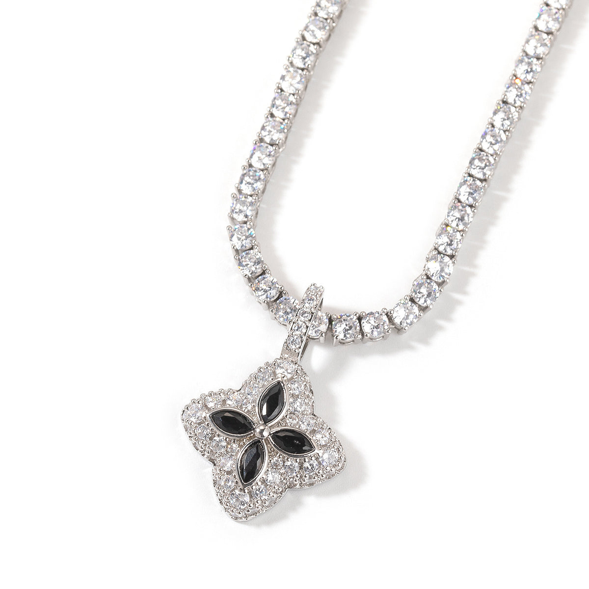Black four-leaf clover pendant styled against a white background