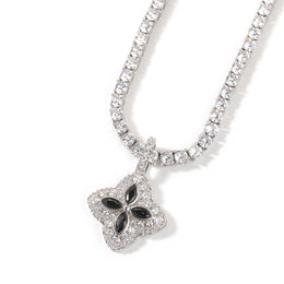 Black four-leaf clover pendant styled against a white background