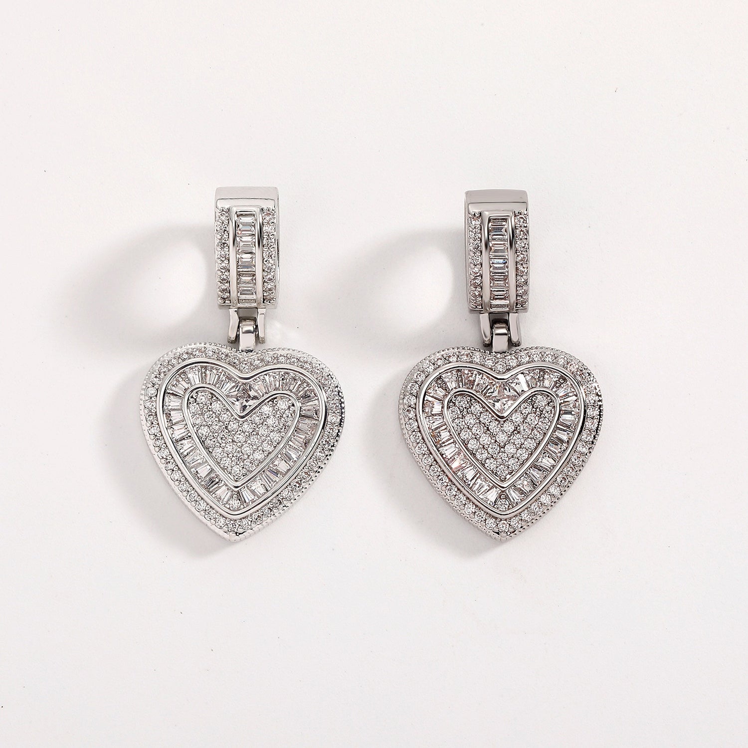 Two silver baguette iced double heart pendants with cubic zirconia