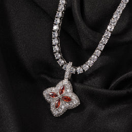 Ruby-red four-leaf clover pendant displayed on black fabric