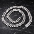 Iced out diamond Cuban link chain on black marble background - Miles Jewellery