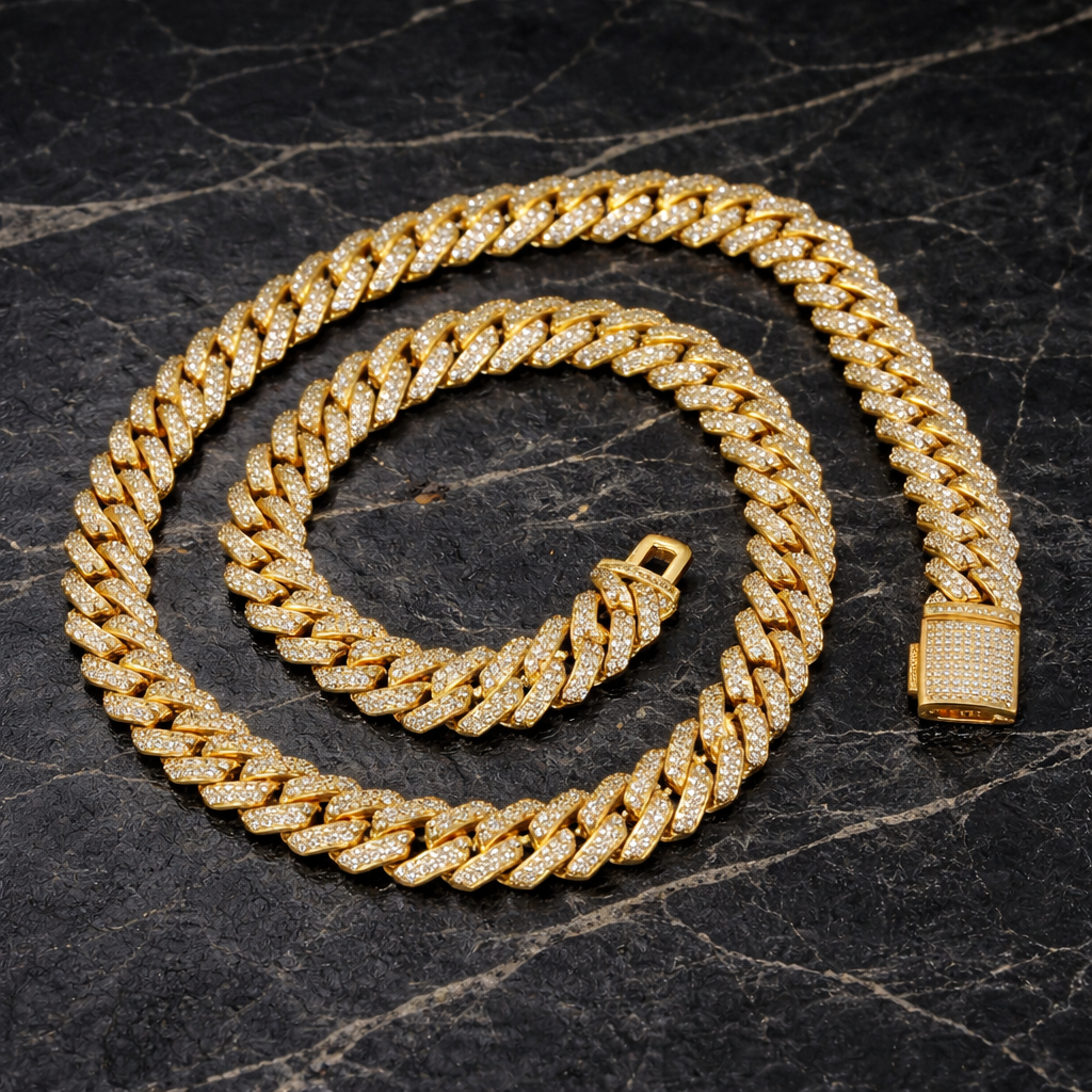 Gold Cuban link chain encrusted with sparkling stones on black marble surface - Miles Jewellery