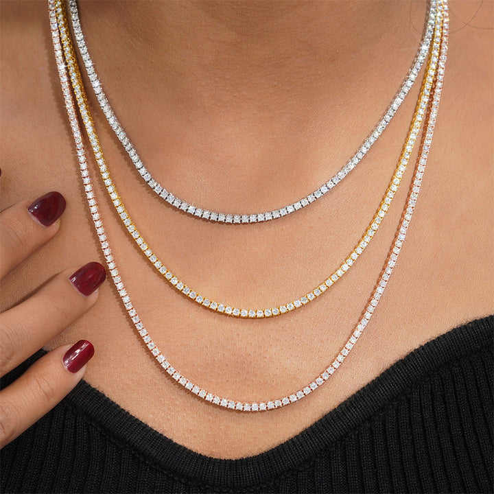 Silver-tone and gold-tone tennis necklaces of different lengths worn together