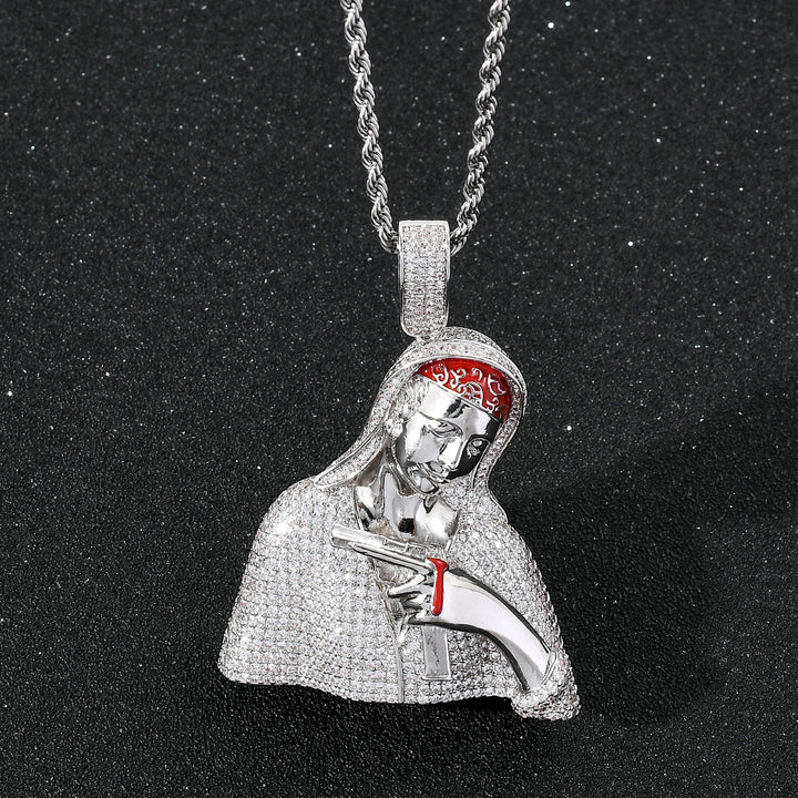 Silver-tone hooded portrait pendant on a dark surface