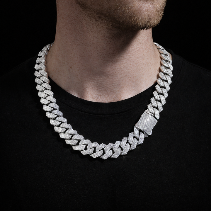 Wide silver-tone stone-set Cuban link necklace worn around the neck