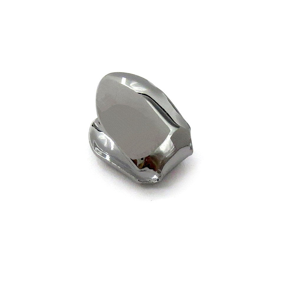 Gunmetal-tone single tooth grill showing the smooth cap and open back
