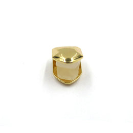 Gold-tone single tooth grill shown straight on with the open back visible