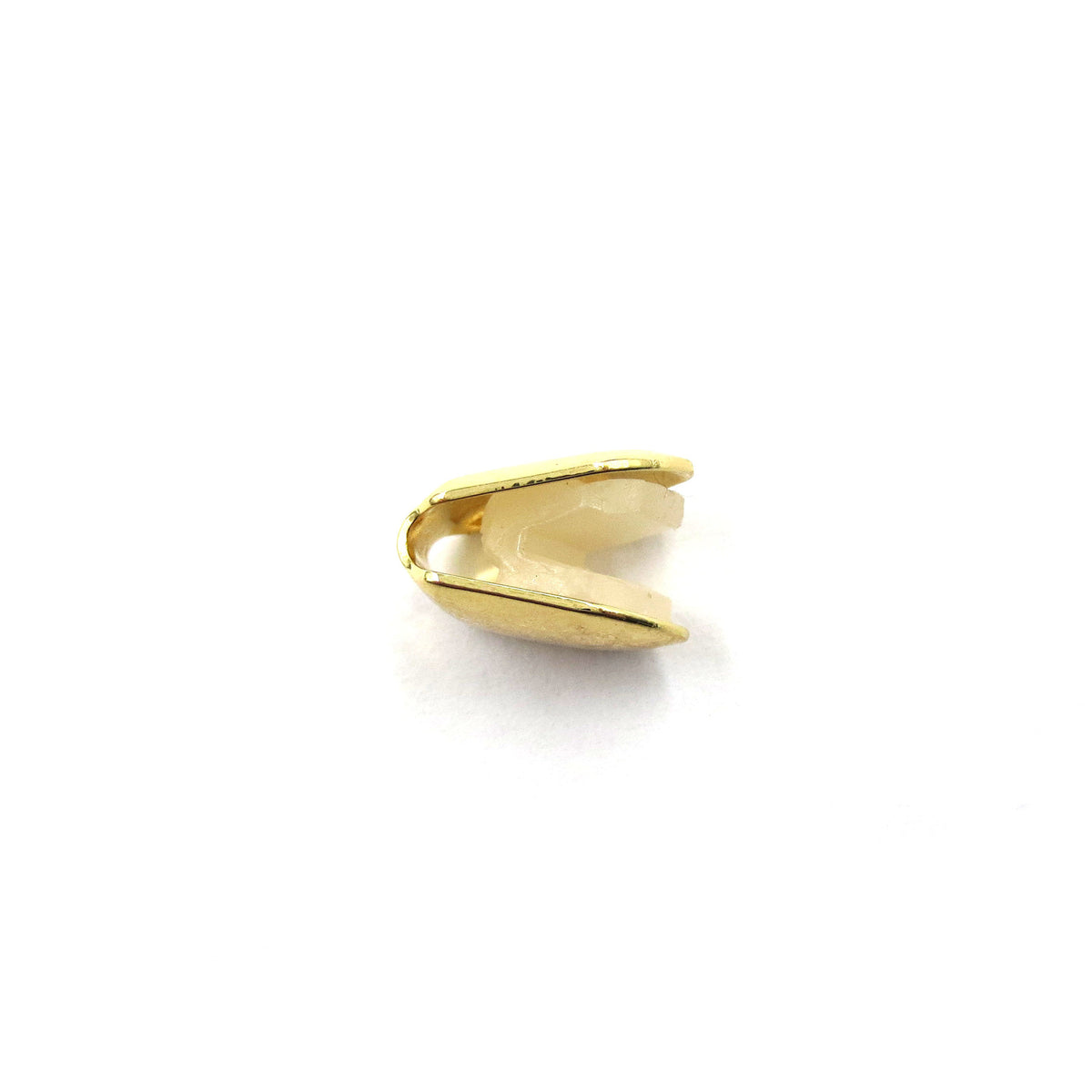Gold-tone single tooth grill in a narrow side profile